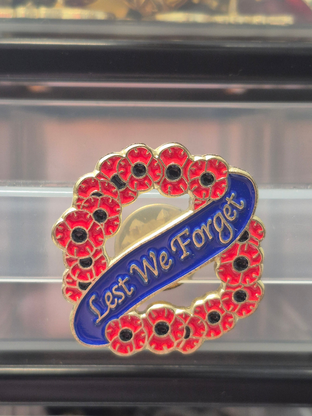 Poppy lapel badge, Lest We Forget